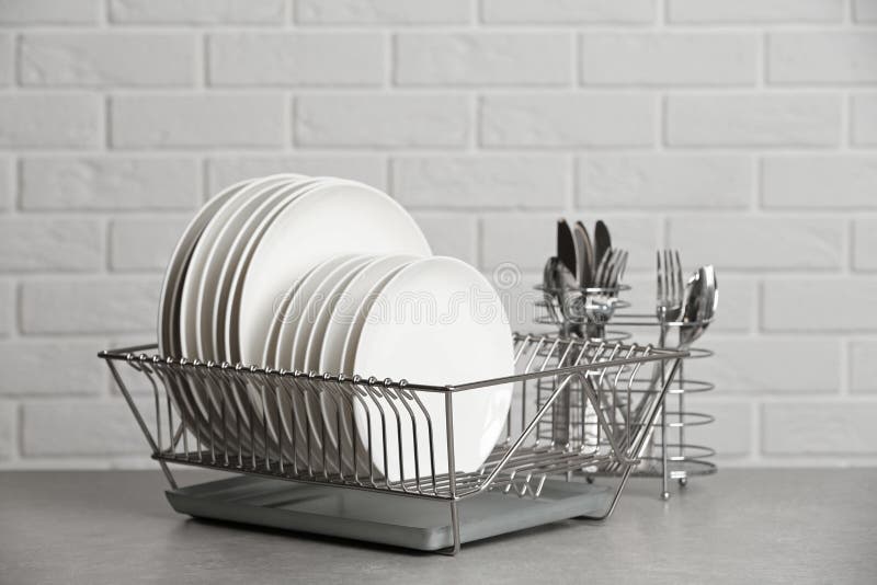 Dish Rack Holds Many Dishes And Cups Against Wooden Countertop White Wall  Tiles Sink And Faucet Budget And Lightweight Antimicrobial Dish Drainer  With Drain Board At Modern Scandinavian Kitchen Stock Photo 