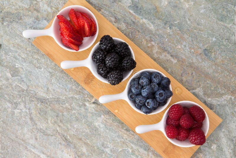 Dishes of fresh berries arranged diagonally