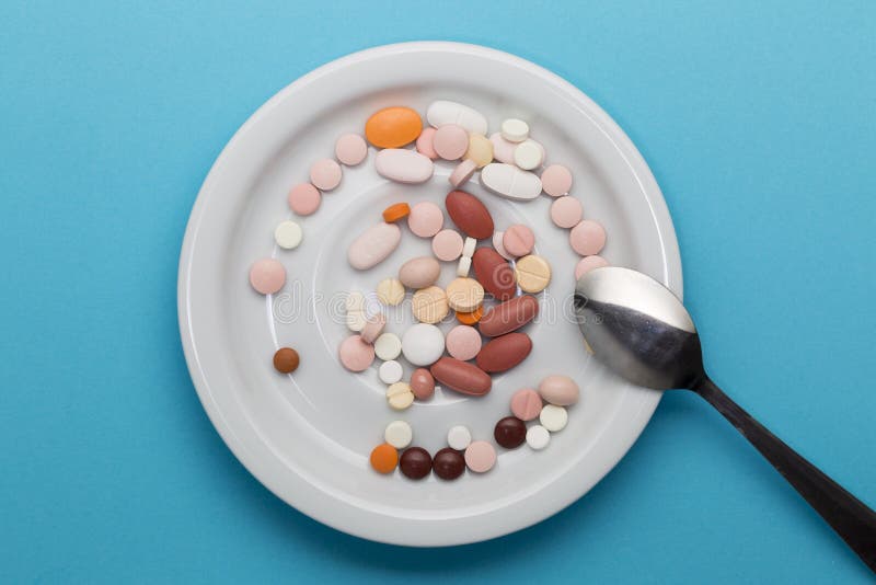 Dishes with Pills on a Plate with Spoon Stock Image - Image of blue
