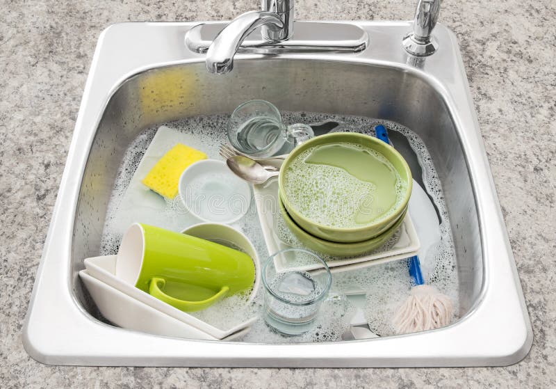 Dishes soaking in the kitchen sink