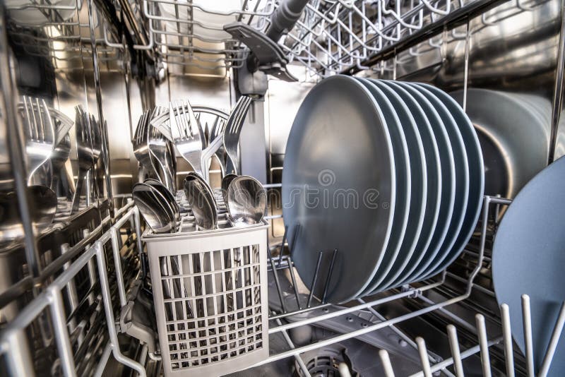 Dishwasher with dishes inside royalty free stock photography