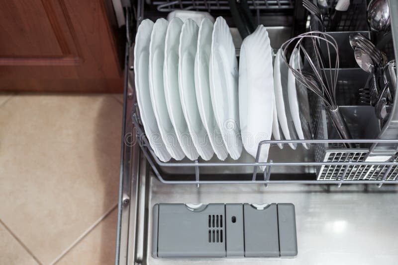 Clean dishes and accessories in dishwasher after washing Stock