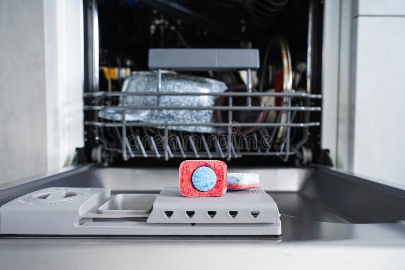 Dishwasher Tablet in a Plastic Dishwashing Container, Closeup Stock