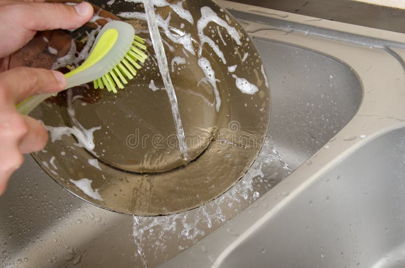 The Dishwasher Washes the Dishes with a Detergent Stock Photo Image
