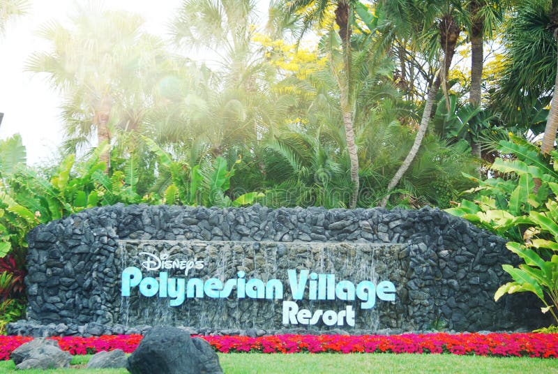 Disney's Polynesian Village Resort sign at entry way with flowers.