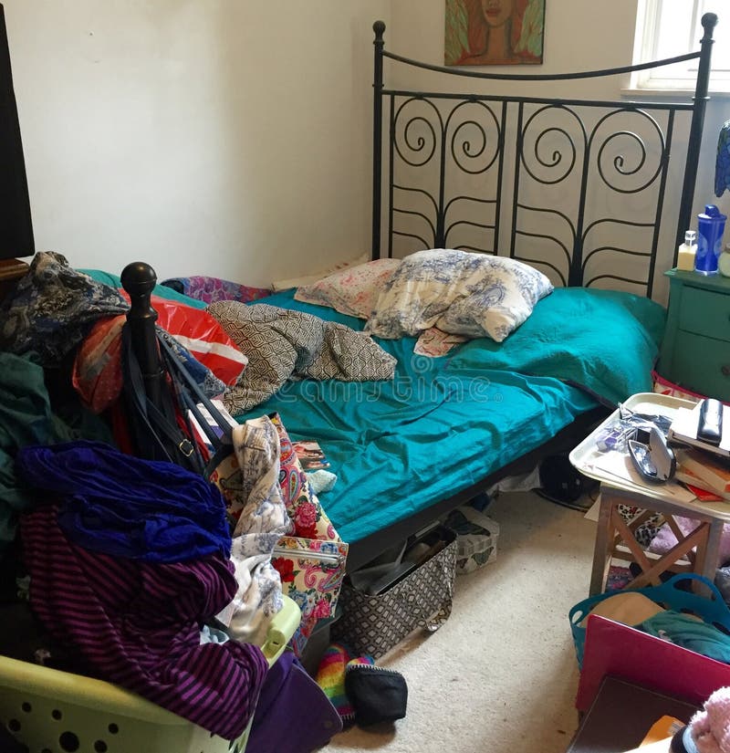 Disorganized bedroom filled with clutter.