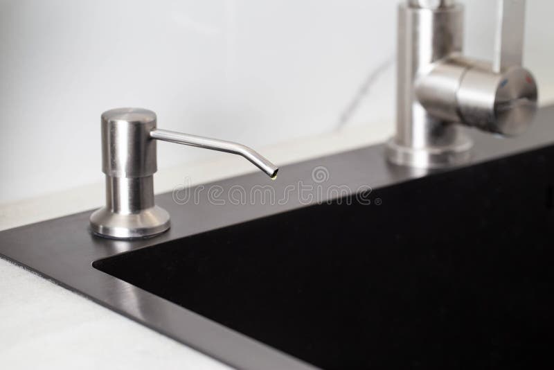 Dispenser in the Kitchen Built into the Sink for Dish Detergent. Copy