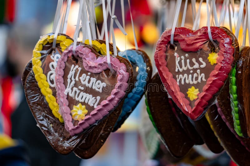 A display of colorful heart-shaped cookies with the words \'Kuess Mich\' written on royalty free stock photography