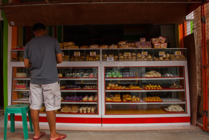 Display window of a bakery and pastry shop of with variety of baked goods, breads, donuts, puff pastry, closeup. Philippines. royalty free stock photo Display window of a bakery and pastry shop of with variety of baked goods, breads, donuts, puff pastry, closeup. Philippines. royalty free stock photo