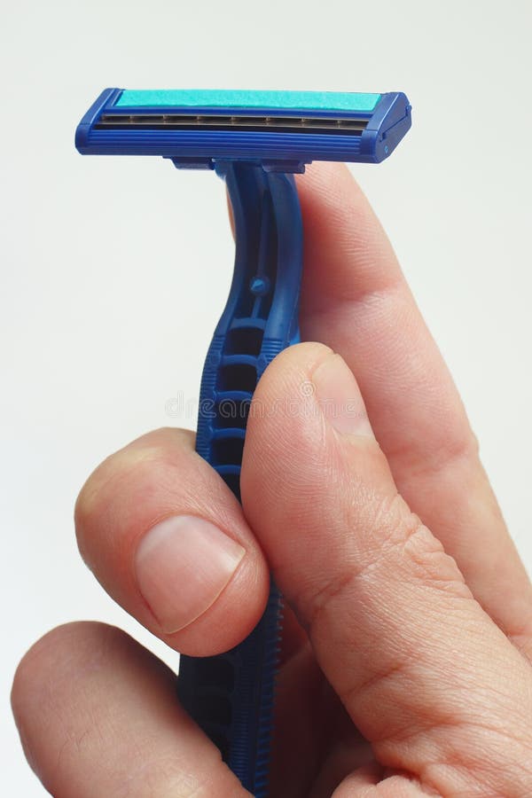 Disposable razor in the hands of man closeup royalty free stock photos Disposable razor in the hands of man closeup royalty free stock photos