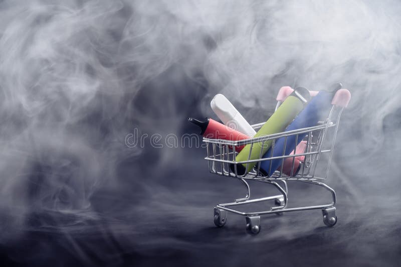 Disposable vapes in a shopping cart on a black background. Modern electronic cigarettes.