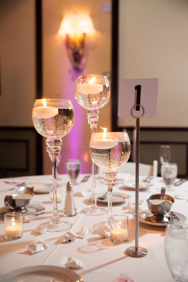 Event table set up with candles inside glasses. Event table set up with candles inside glasses.