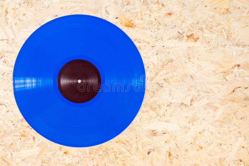 Disque Vinyle Bleu De Couleur Sur Le Fond De Contreplaqué Photo stock -  Image du disque, discothèque: 128442314