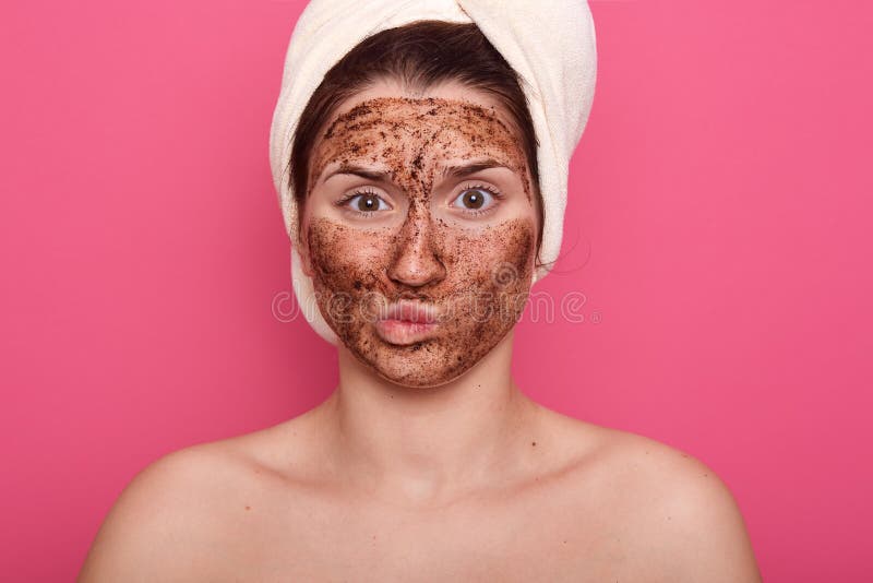 Dissatisfied young woman doesnt like smell from beauty mask, doing procedures for removing wrinkles on face, wearing white towel stock photos Dissatisfied young woman doesnt like smell from beauty mask, doing procedures for removing wrinkles on face, wearing white towel stock photos