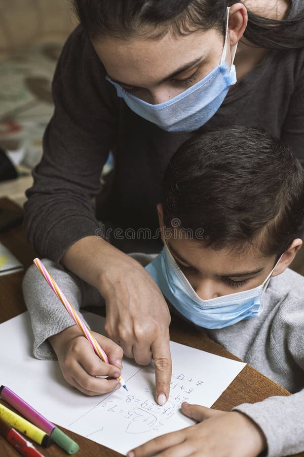 Distance education. Mother helps a pre-school kid to do lessons stock images Distance education. Mother helps a pre-school kid to do lessons stock images