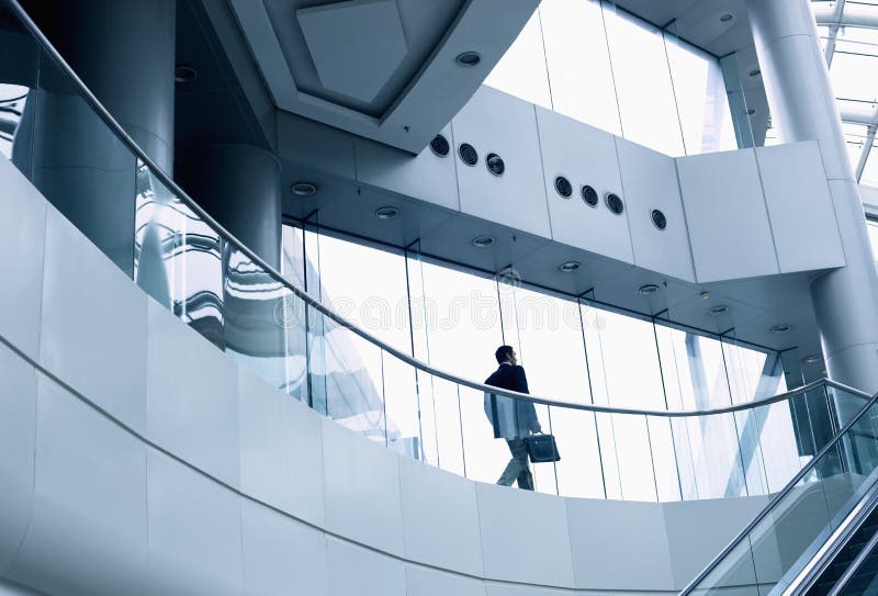 Distant businessman walking in a modern office building