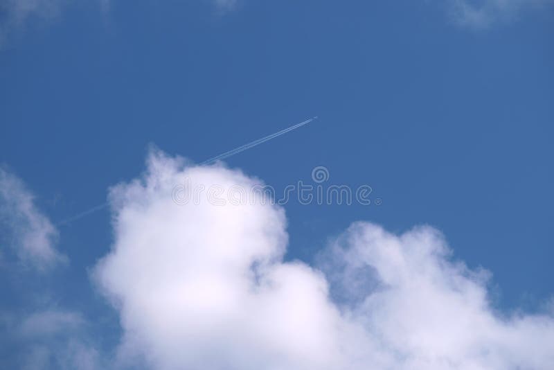 Distant Passenger Jet Plane Flying on High Altitude on Blue Sky with ...