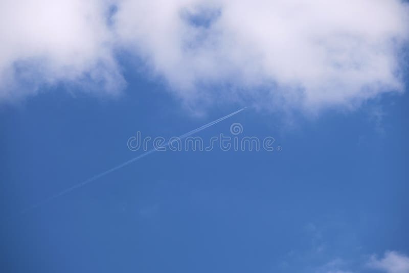 Distant Passenger Jet Plane Flying on High Altitude on Blue Sky with ...