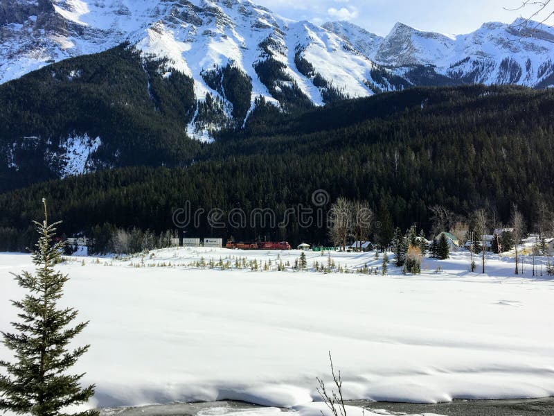 A distant view of the town of Field, in British Columbia Canada, during winter. The landscape is covered in snow and the rocky mou stock photo A distant view of the town of Field, in British Columbia Canada, during winter. The landscape is covered in snow and the rocky mou stock photo