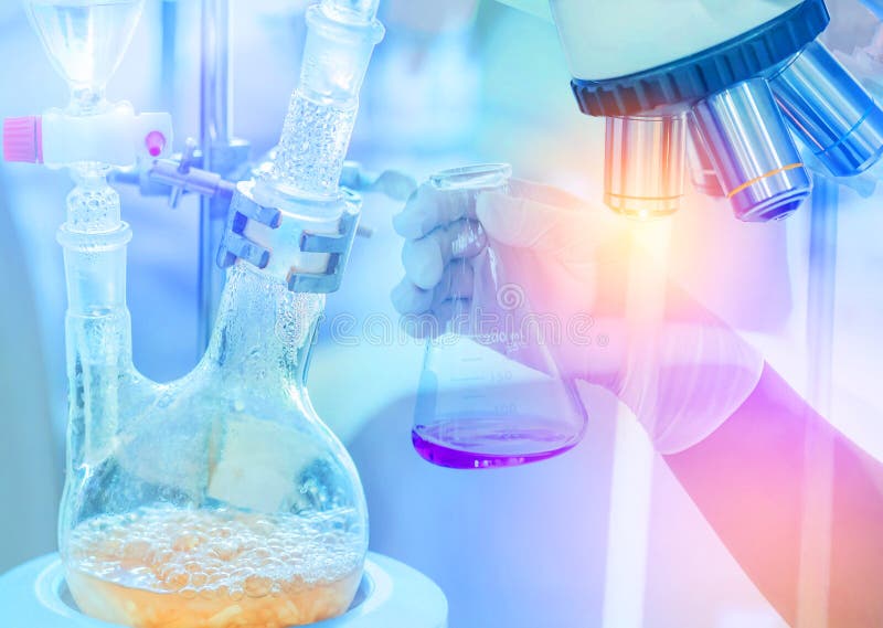 Distillation set with dropping funnels is separating the component substances from liquid mixture with hand scientist holding flas stock photo Distillation set with dropping funnels is separating the component substances from liquid mixture with hand scientist holding flas stock photo