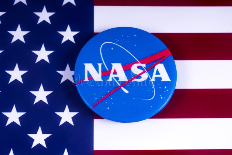 LONDON, UK - MARCH 18TH 2018: NASA badge pictured over the USA flag, on 18th March 2018. NASA is the independent agency of of the US federal government responsible for the civilian space program and aerospace research. LONDON, UK - MARCH 18TH 2018: NASA badge pictured over the USA flag, on 18th March 2018. NASA is the independent agency of of the US federal government responsible for the civilian space program and aerospace research.