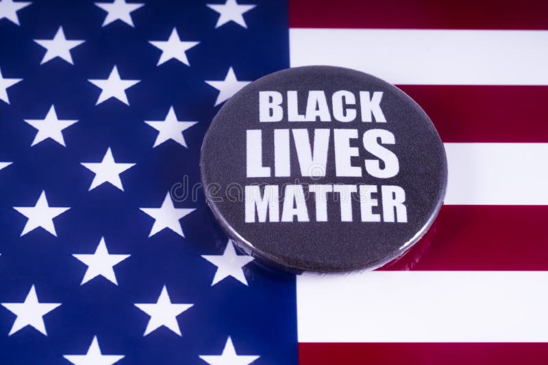 LONDON, UK - MARCH 18TH 2018: A Black Lives Matter badge over a US flag background, on 18th March 2018. BLM is an activist movement originating in the African-American community, campaigning against violence and racism towards black people. LONDON, UK - MARCH 18TH 2018: A Black Lives Matter badge over a US flag background, on 18th March 2018. BLM is an activist movement originating in the African-American community, campaigning against violence and racism towards black people.