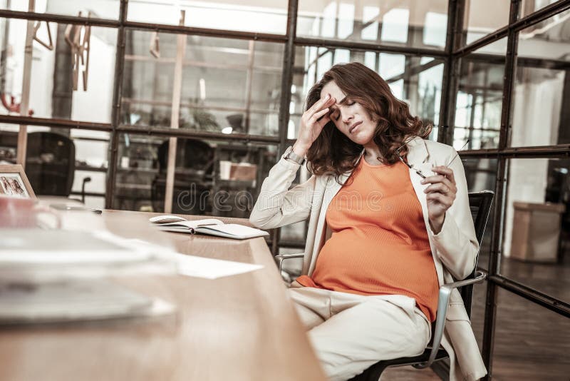 Disturbed long-haired woman being in hard emotional and physical condition royalty free stock photography Disturbed long-haired woman being in hard emotional and physical condition royalty free stock photography