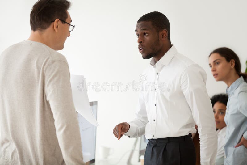 Diverse black employee and white boss arguing in office, african worker disagreeing with dismissal firing protecting rights or behaving rudely, multiracial conflict at work and racial discrimination. Diverse black employee and white boss arguing in office, african worker disagreeing with dismissal firing protecting rights or behaving rudely, multiracial conflict at work and racial discrimination