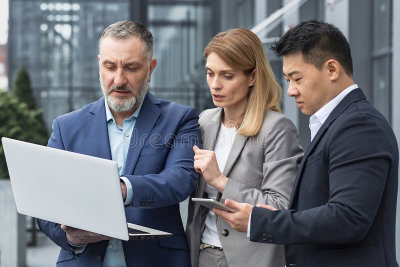 Diverse Business Group of Three People Talking and Discussing Strategy