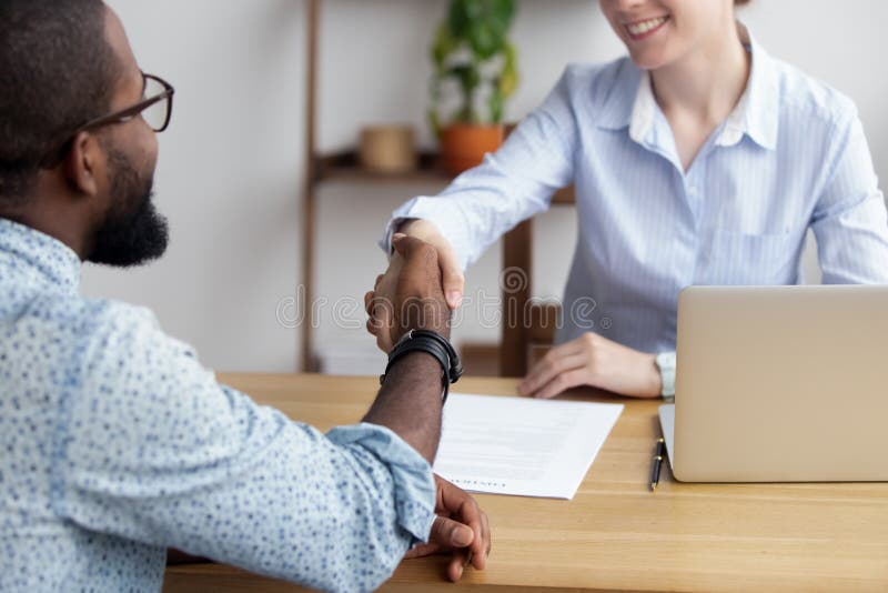 Diverse business people shaking hands greeting each other stock images Diverse business people shaking hands greeting each other stock images
