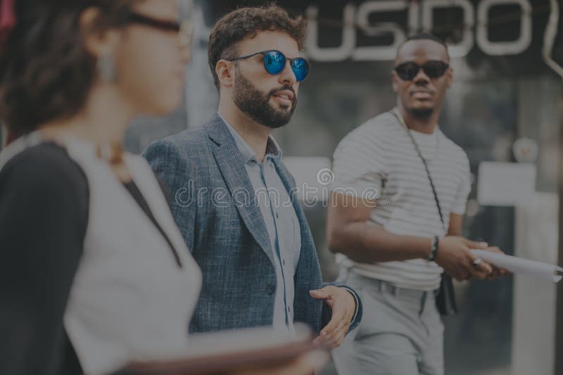 Diverse business team collaborating in urban outdoor setting stock image