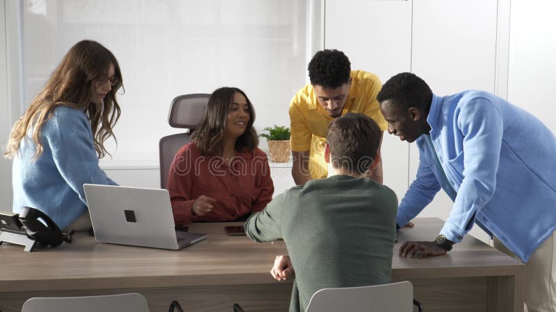 Startup team discussing a project on a laptop stock footage