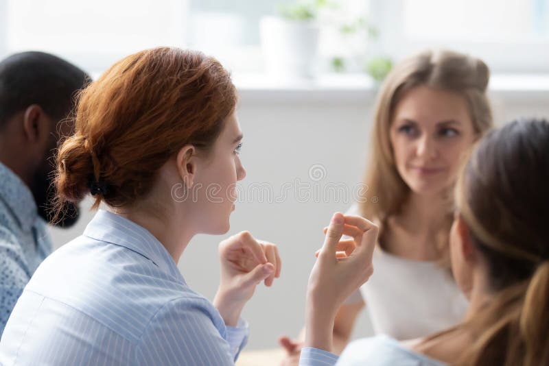 Diverse office workers talking during business meeting