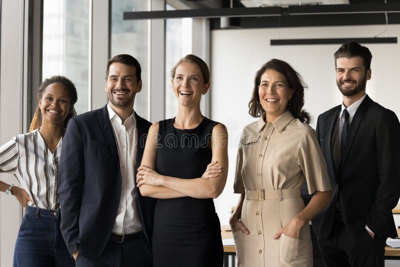 Diverse corporate members, executives, managers represent company posing at workplace stock photography