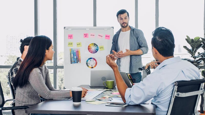 Diverse creative designer meeting at office. employee brainstroming idea and planning for project with white board royalty free stock photography.