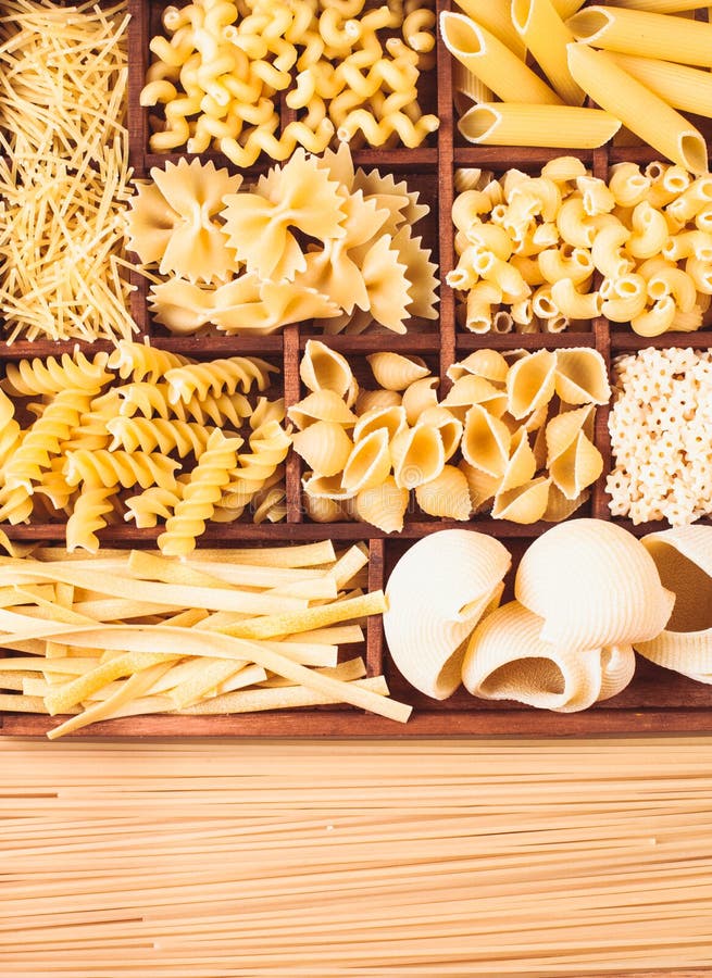 Various pasta types in the wooden box on the table. Various pasta types in the wooden box on the table