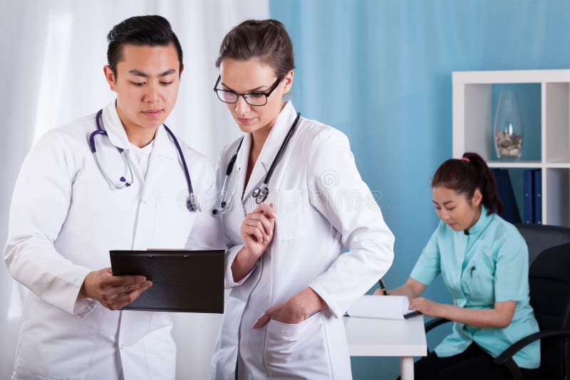 Diverse doctors talking at work stock photo Diverse doctors talking at work stock photo