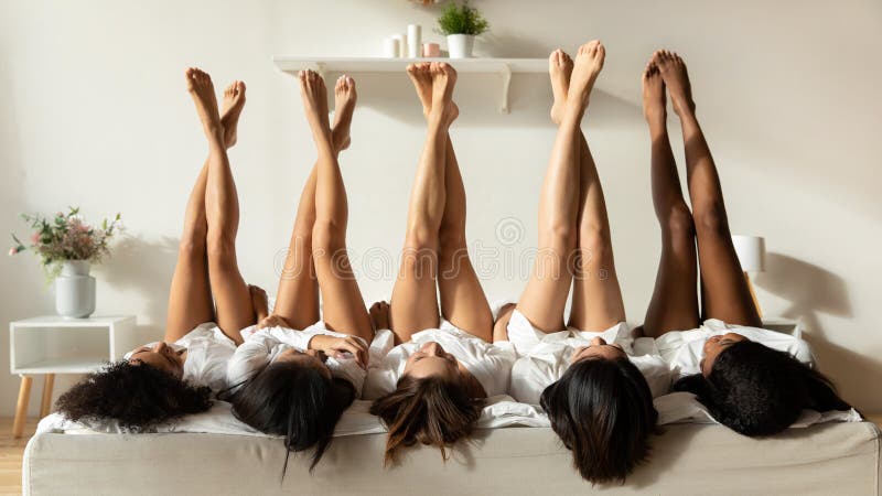 Diverse girls lie upside down celebrate hen party
