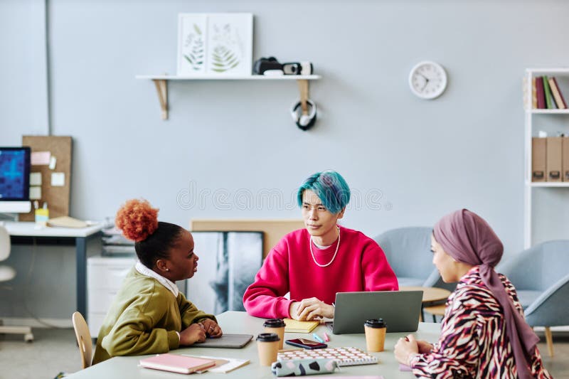 Diverse group of creative young people brainstorming project during meeting royalty free stock photography