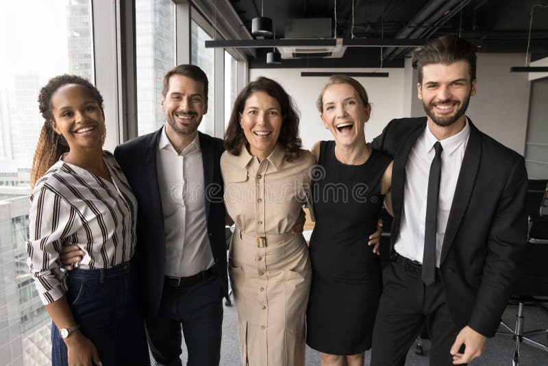 Diverse group of five businesspeople standing together in office royalty free stock images