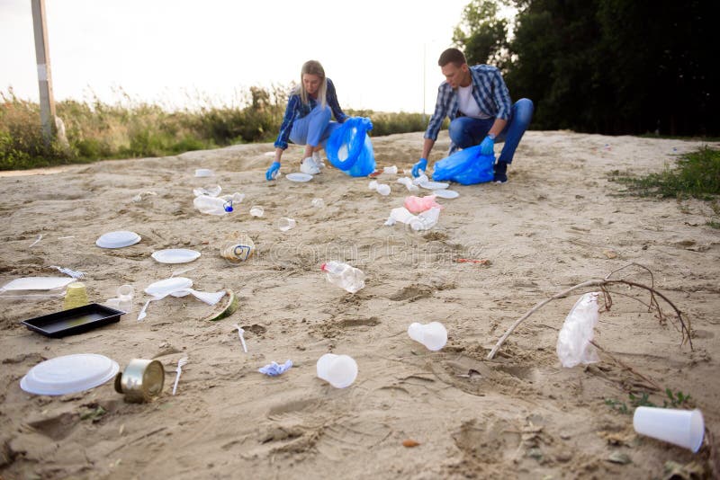 Diverse Group Of People Picking Up Trash In The Park Volunteer