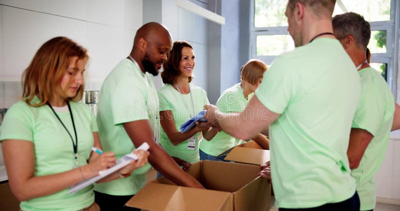Diverse Group Of People Sorting Clothes Donations. Charity sorting stock images, royalty-free photos and pictures