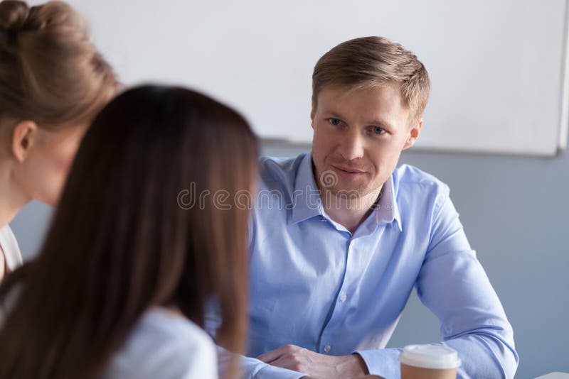 Diverse millennial colleagues have talk during office break stock photos Diverse millennial colleagues have talk during office break stock photos