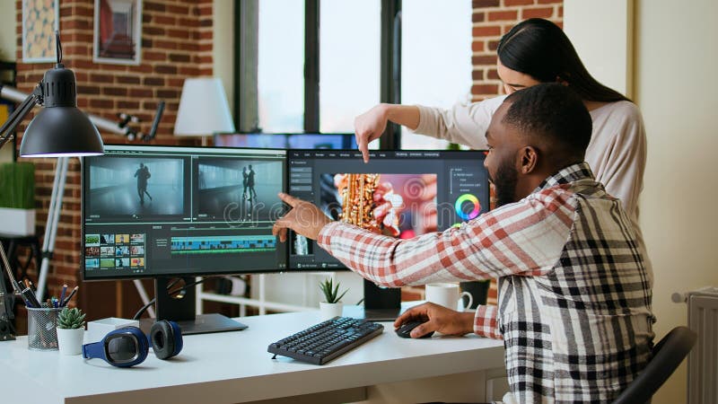 Diverse mixed race couple working as a team for a freelance video shoot stock photography
