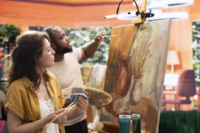 Diverse painters apply watercolor paint with brushstrokes for certain technique royalty free stock photos