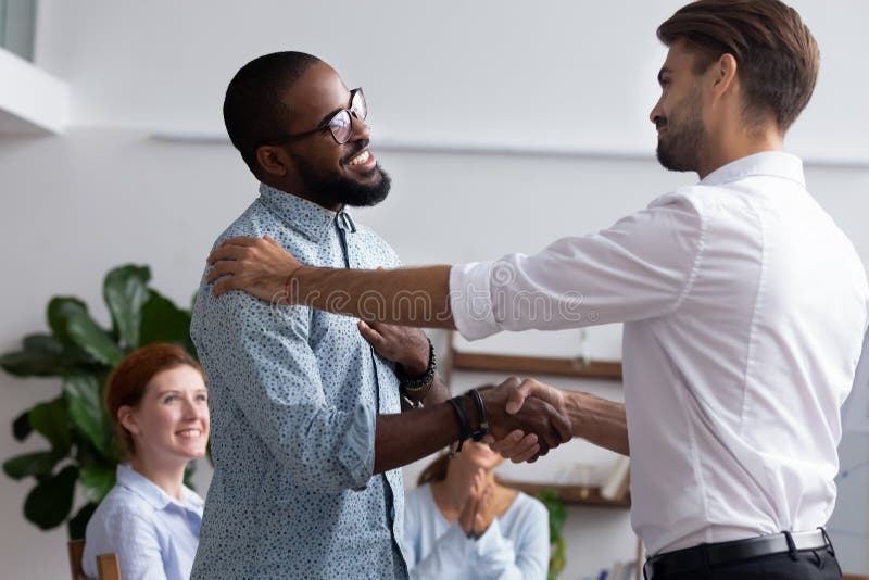 Company boss congratulating handshaking with successful employee stock photo Company boss congratulating handshaking with successful employee stock photo