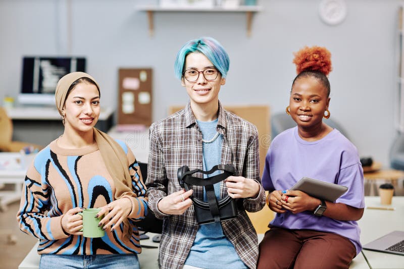Team of creative young professionals looking at camera in office stock photo