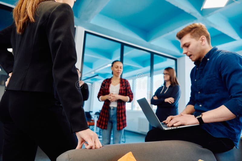 A diverse team of young business people exchanging ideas in a modern startup office stock images