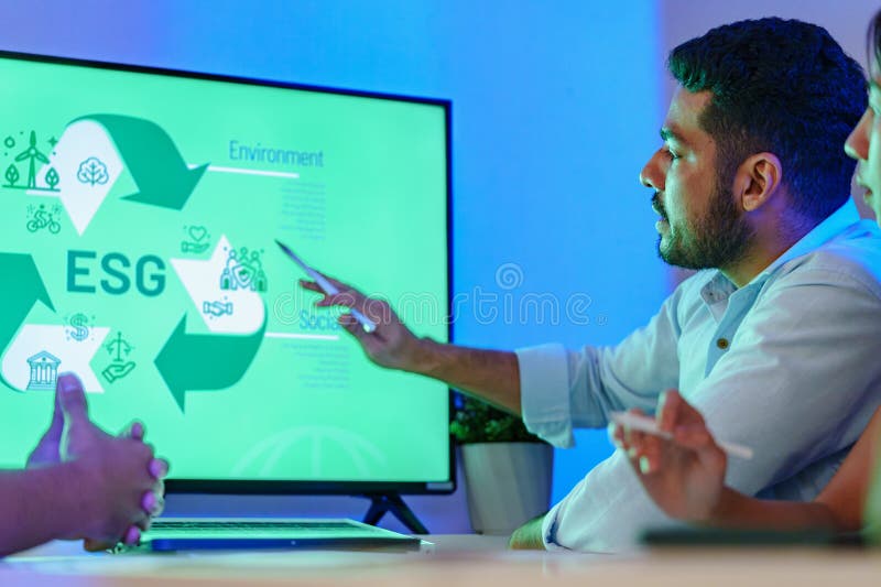 Diversity team presentation about ESG sustainability business goals sdgs in green office at night royalty free stock images