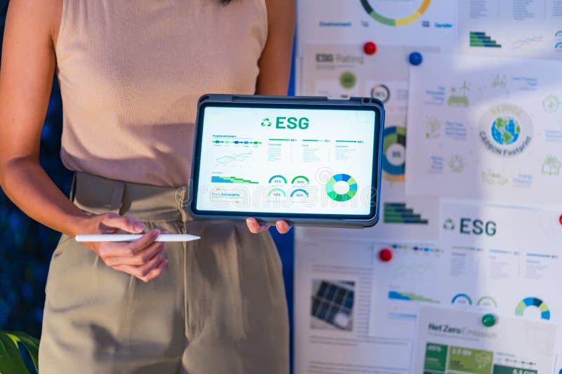 Diversity team presentation about ESG sustainability business goals sdgs in green office at night stock photography